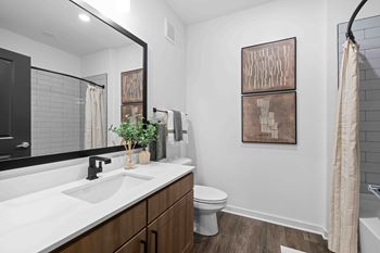 A bathroom with a white sink and a toilet.